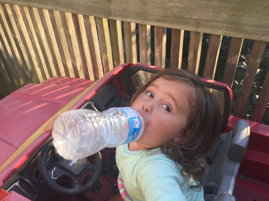 kid drinking water on a warm summer day in kids electric chevy truck, woodstock ontario