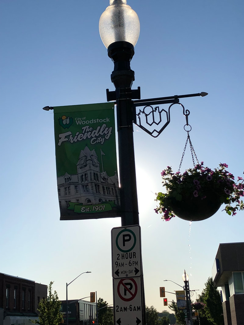 welcome lighpost dundas st woodstock with flowers