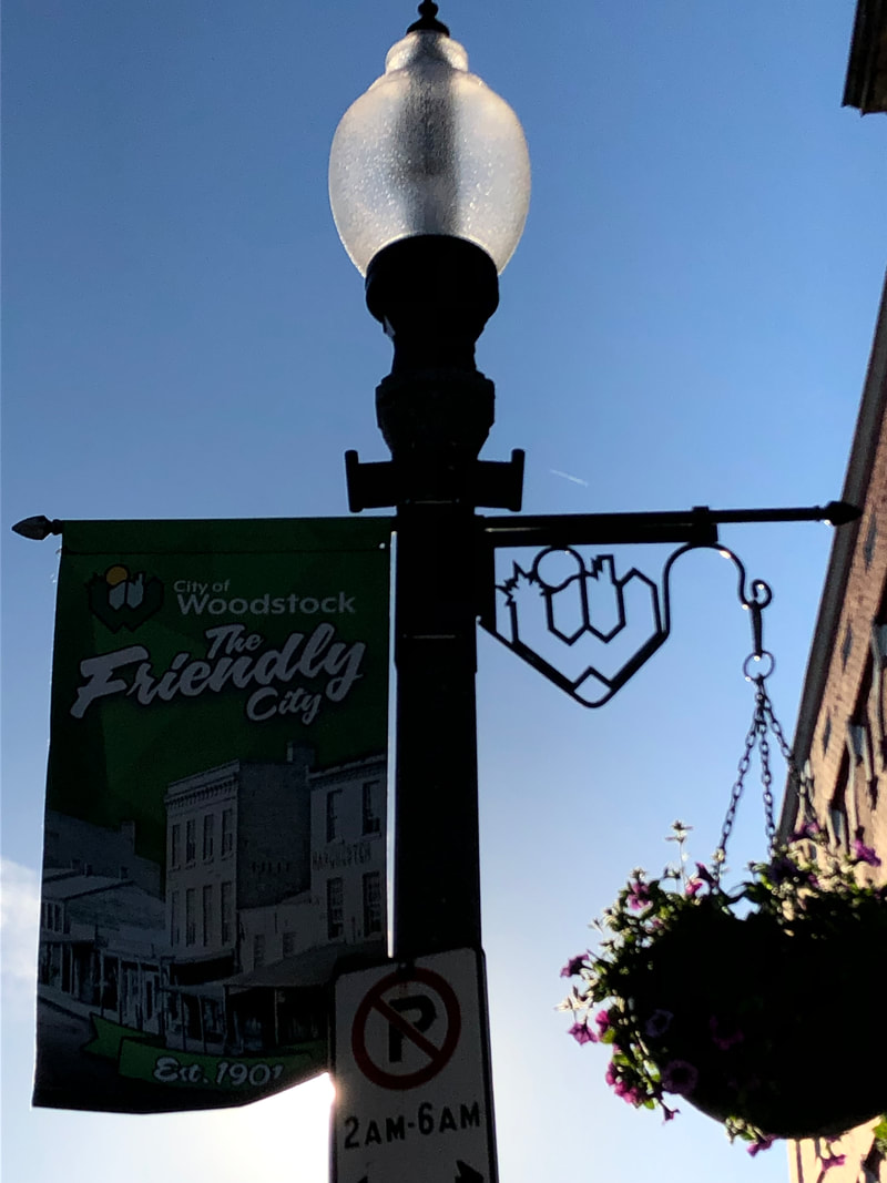 woodstock on welcome lightpost sign with flowers