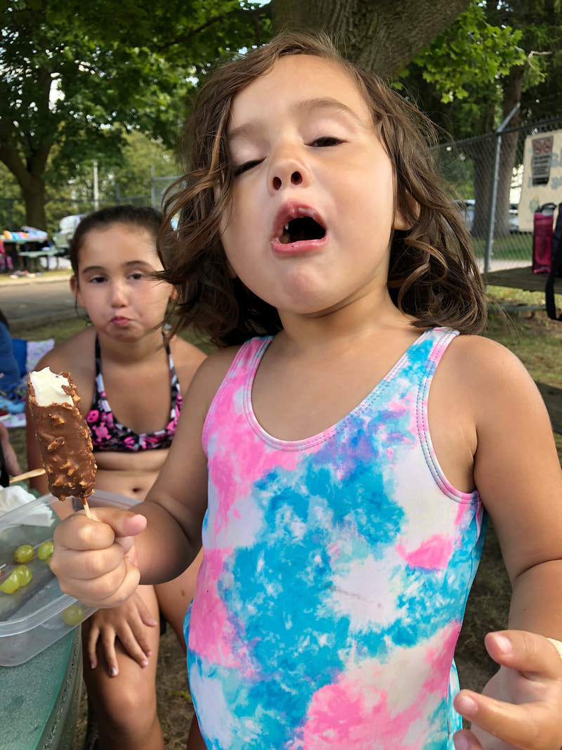 woodstock splashpad fun - toddler eats ice cream bar that's really cold, southside park splash pad woodstock