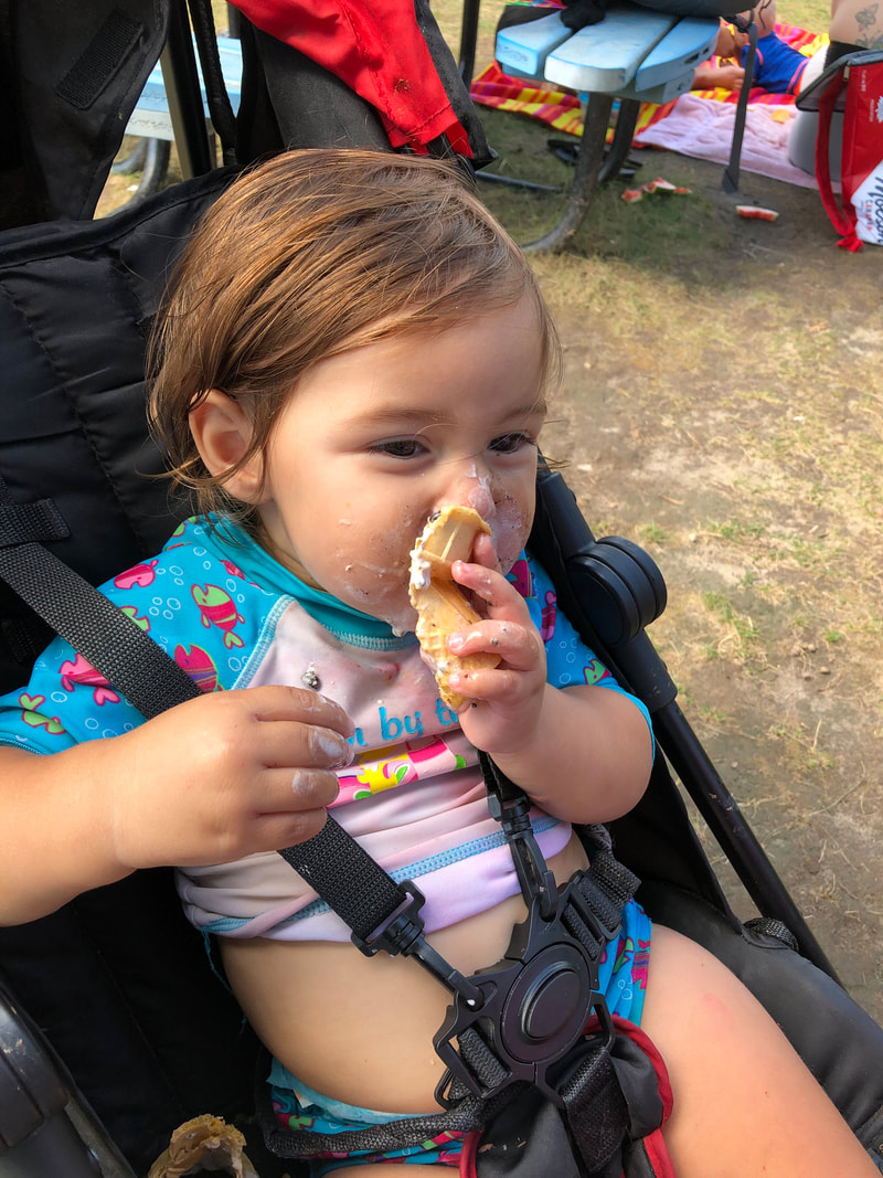woodstock splashpad fun - baby still eating her ice cream mess, southside park splash pad woodstock