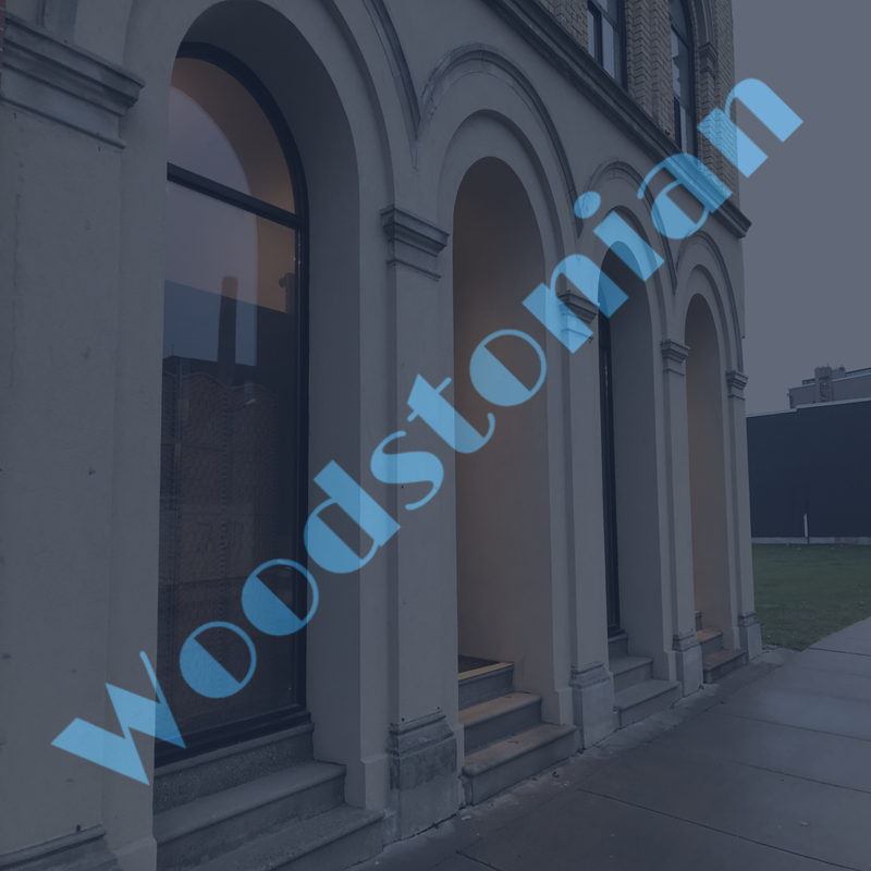 WOODSTONIAN logo over building